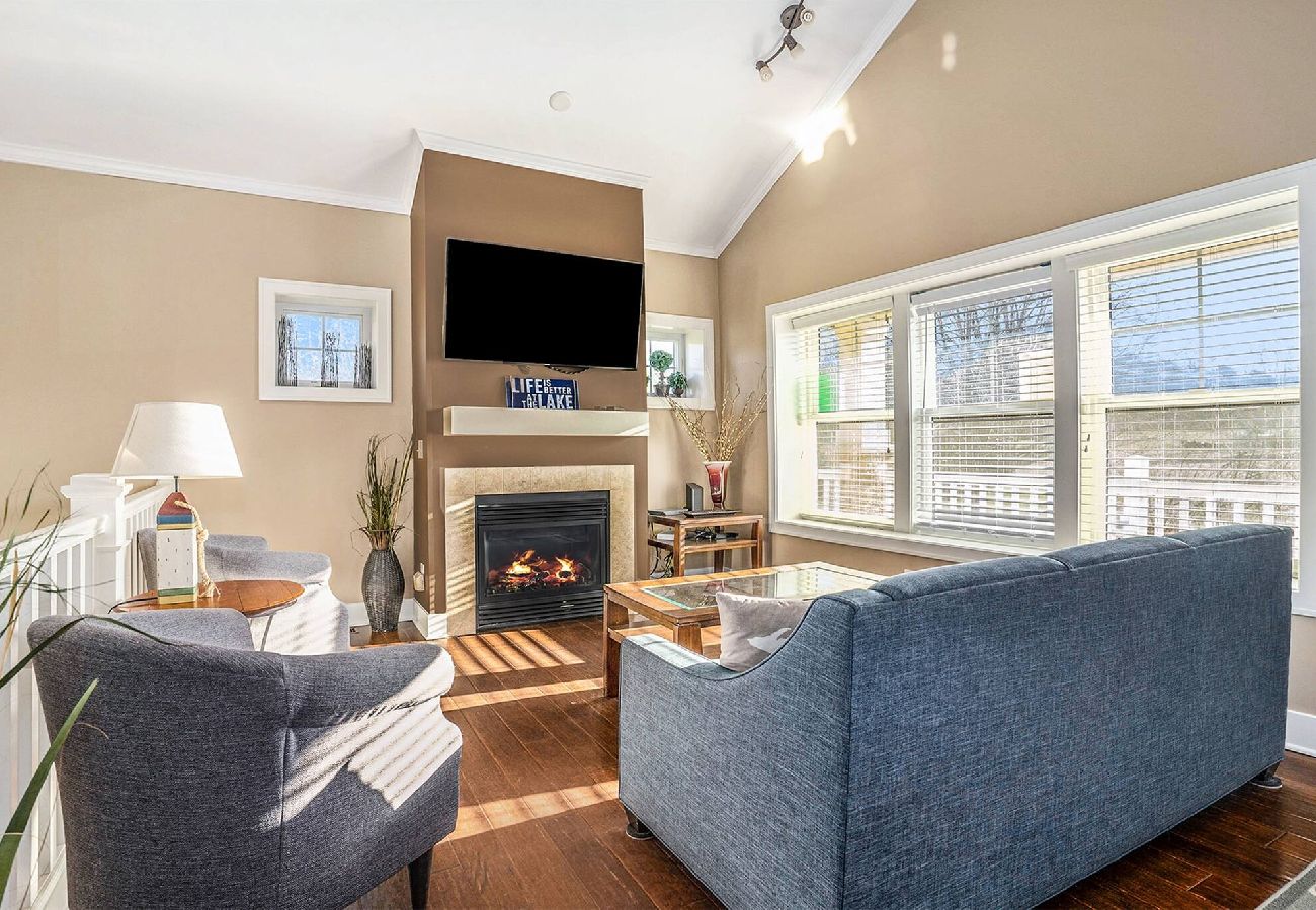 Living room with vaulted ceiling, and gas fireplace