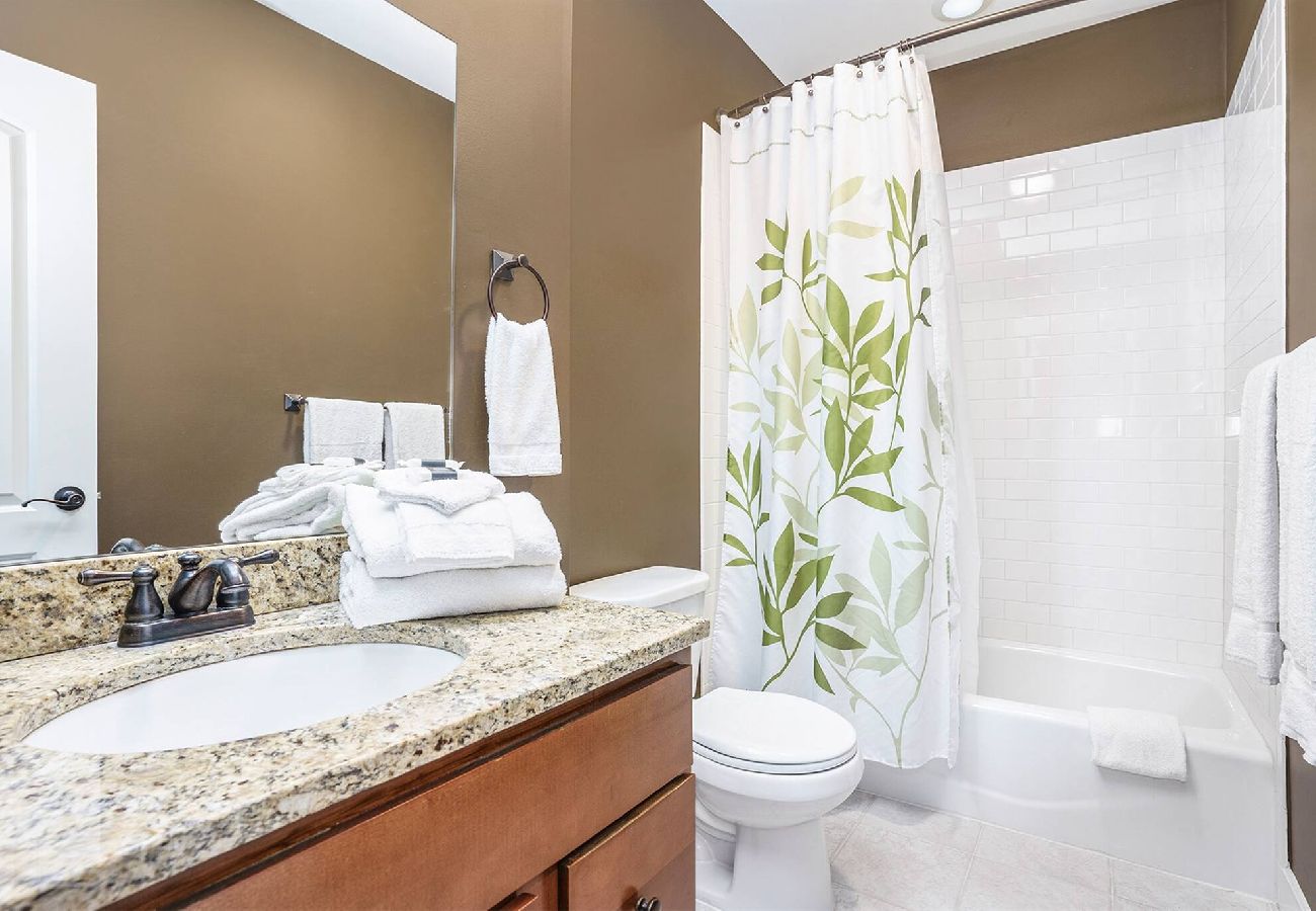 Main level hall bathroom with granite vanity,full shower and tub