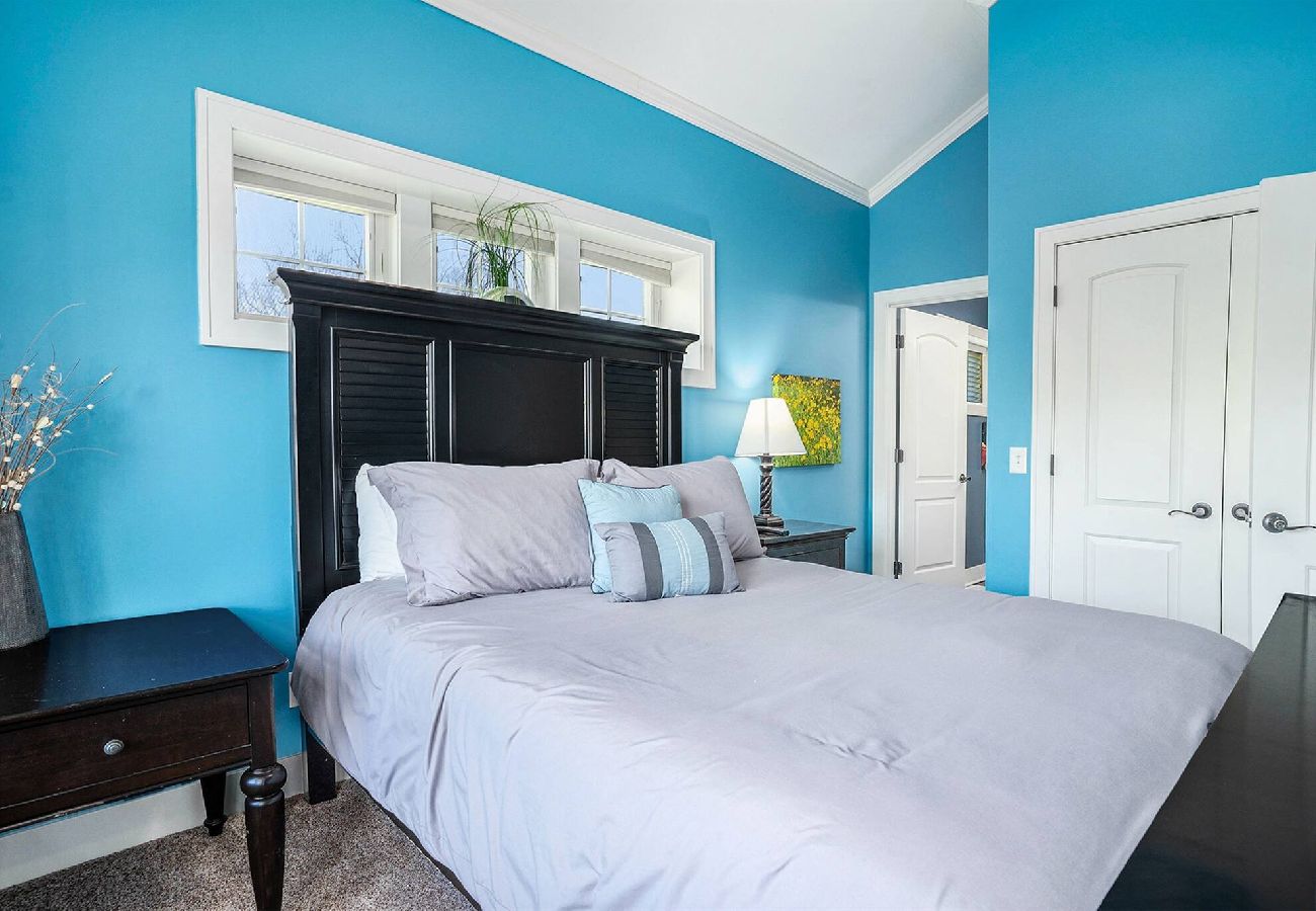 Comfortable primary bedroom with private door to en-suite bathroom