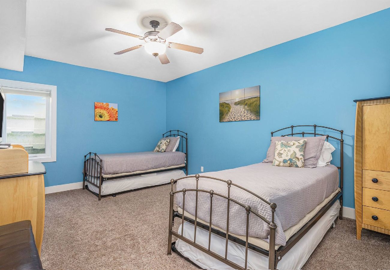 Basement bedroom with two twin trundle beds.