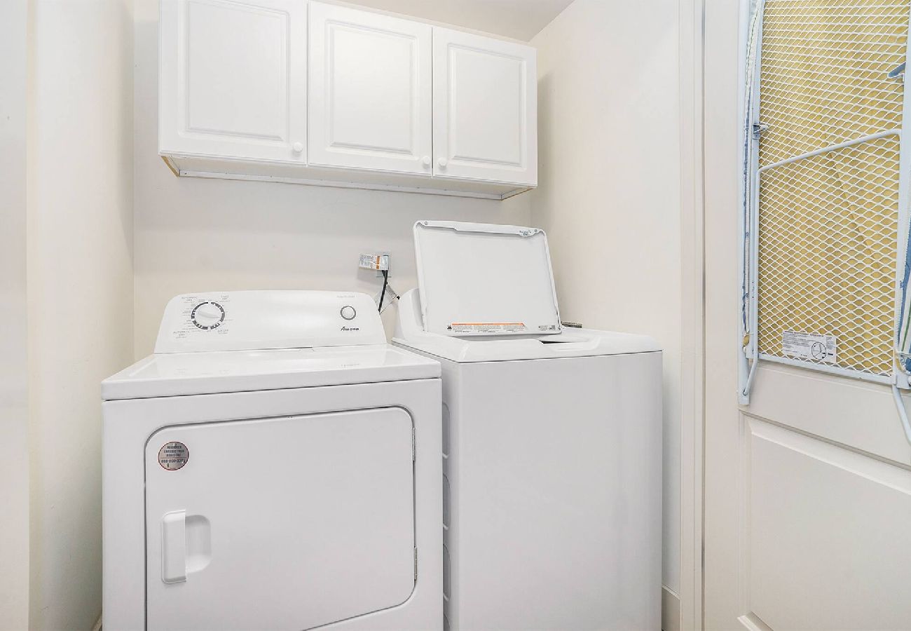 Basement laundry area with full-size washer & dryer
