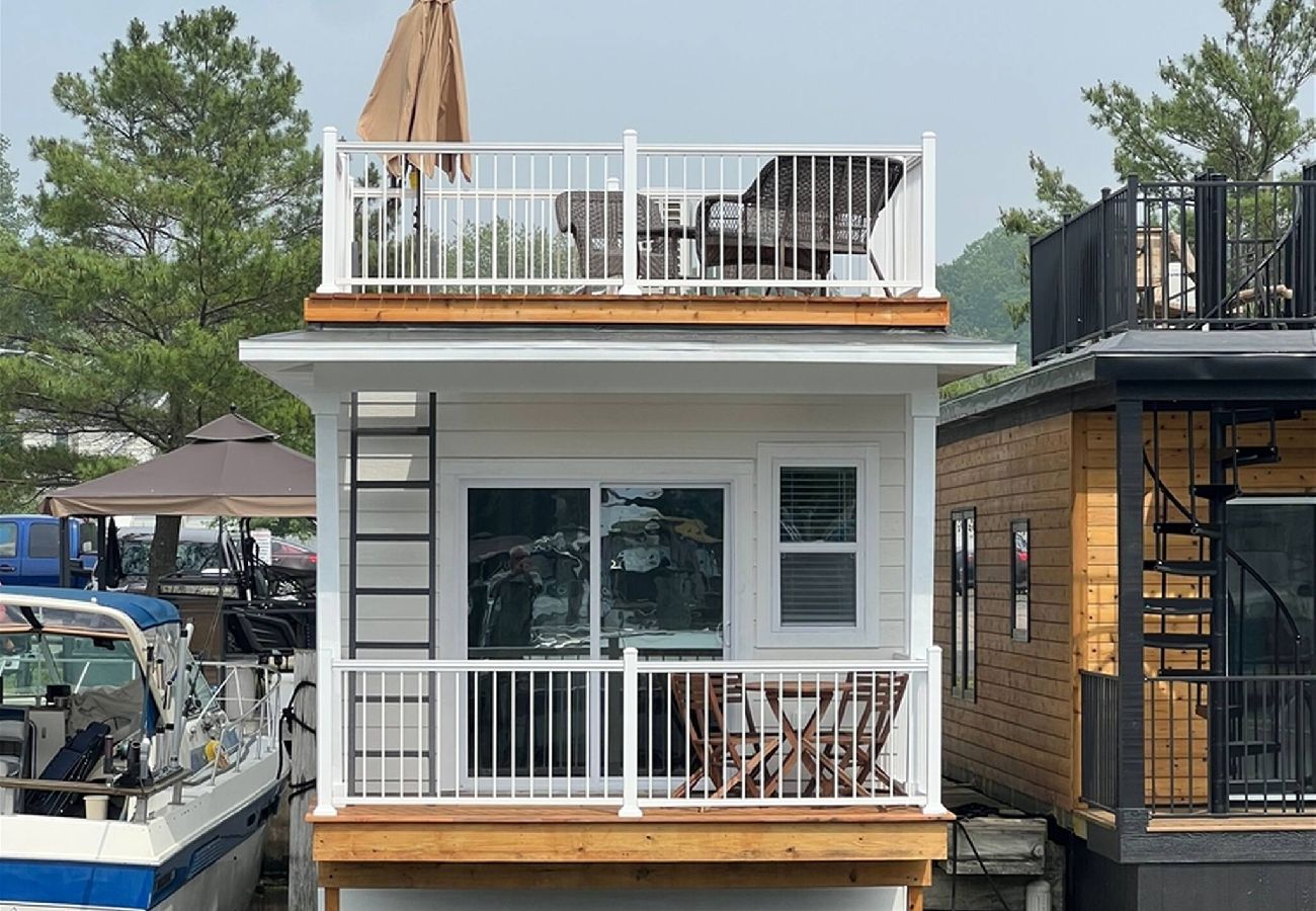 River side view of the Morning Glory tiny floating cottage