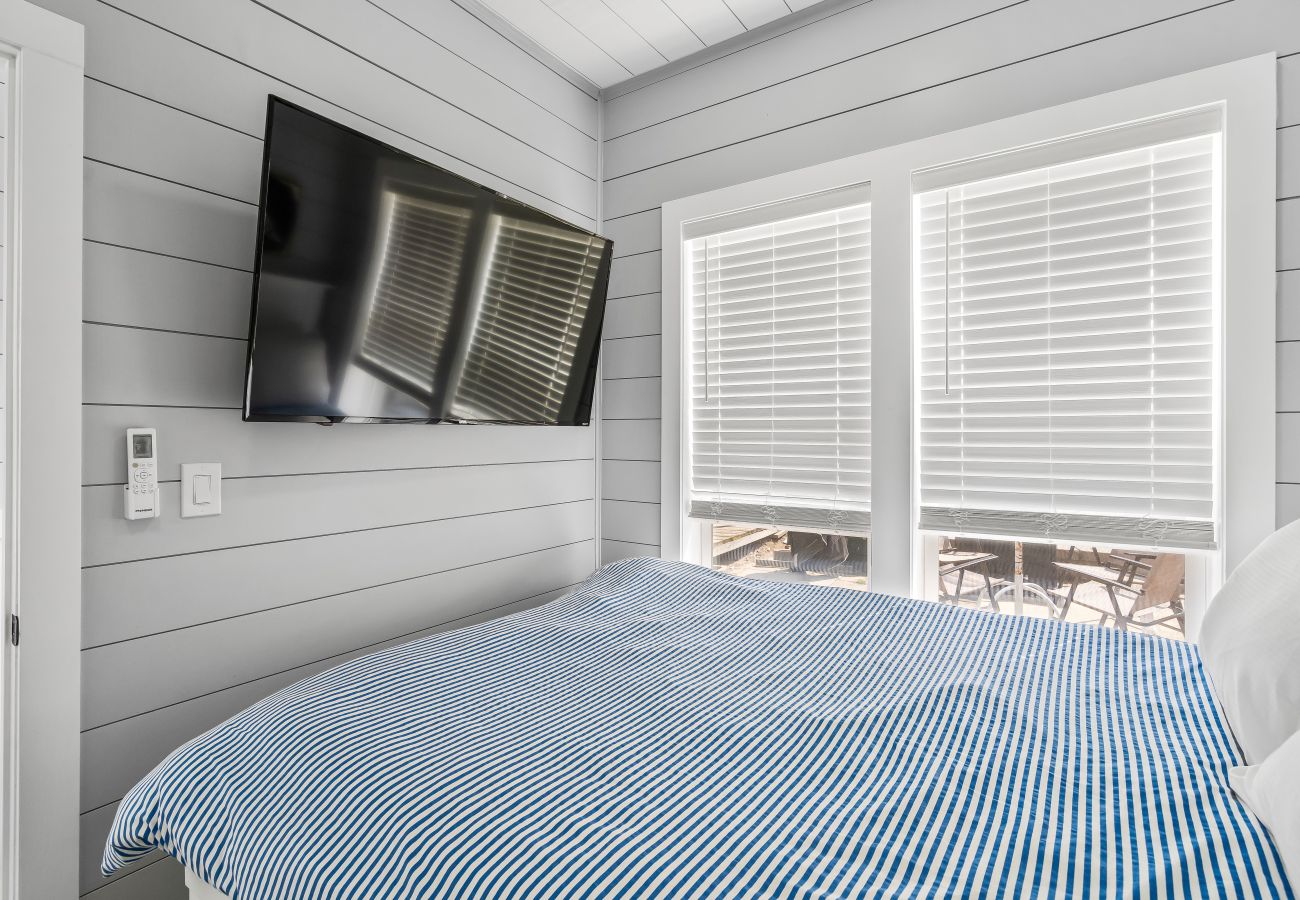 Bright windows and wall-mounted TV at Morning Glory Floating Cottage