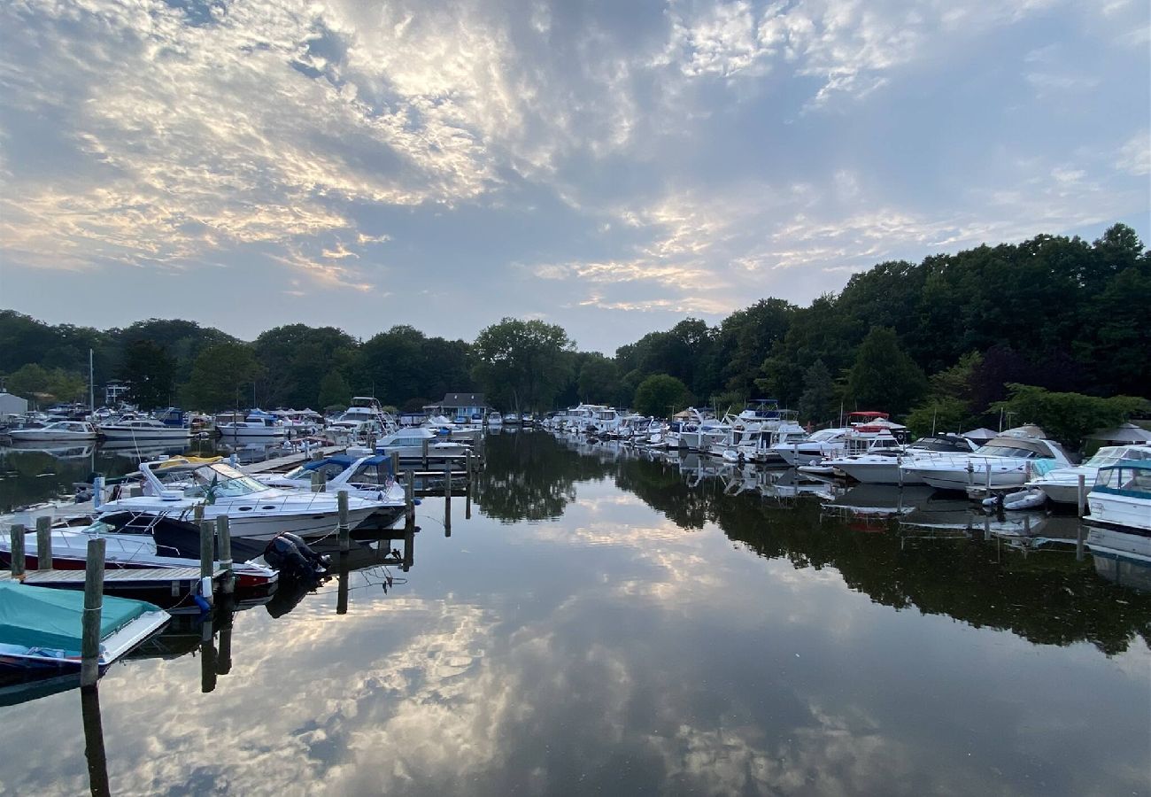 Calm marina with boats reflecting on still water near Aqua Vista Floating Cottage in South Haven