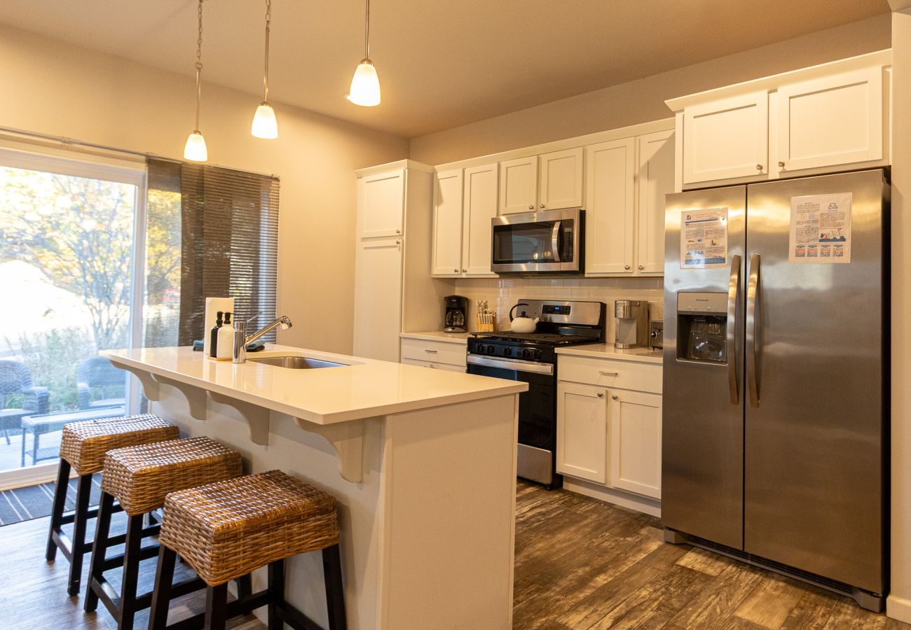 Harbor Pointe kitchen with stainless steel appliances, large island, and sliding doors leading to the patio