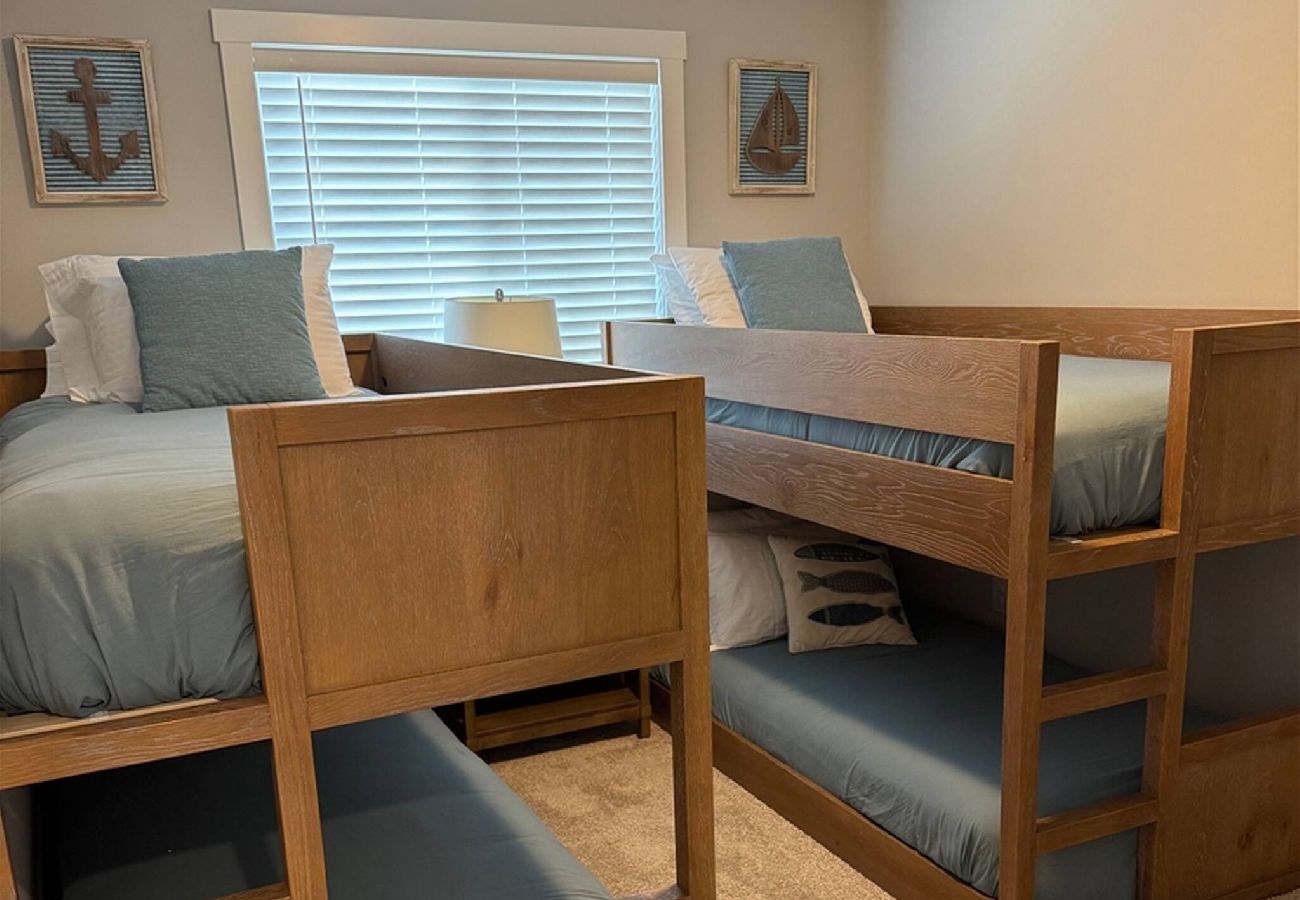 Wooden bunk beds with blue bedding and nautical decor at Blissful Daze
