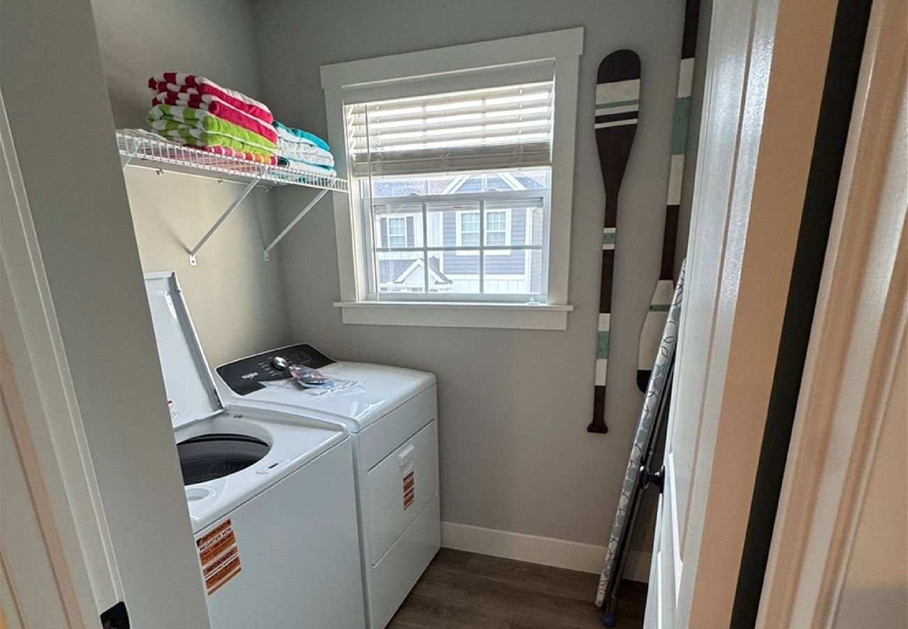 Laundry room with full-size washer and dryer and shelving