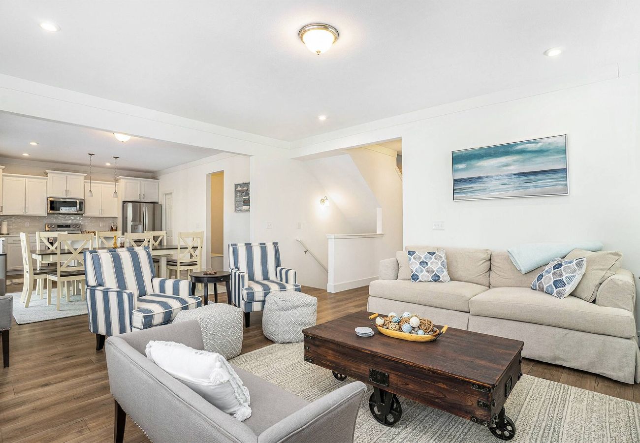 Open living room, and a view of the adjacent kitchen and dining room
