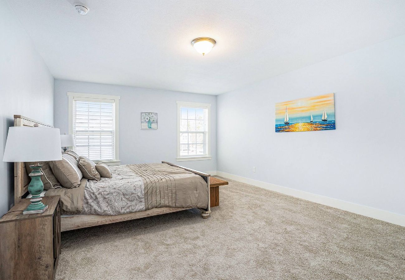 Large primary bedroom with a king bed and access to the en-suite primary bathroom