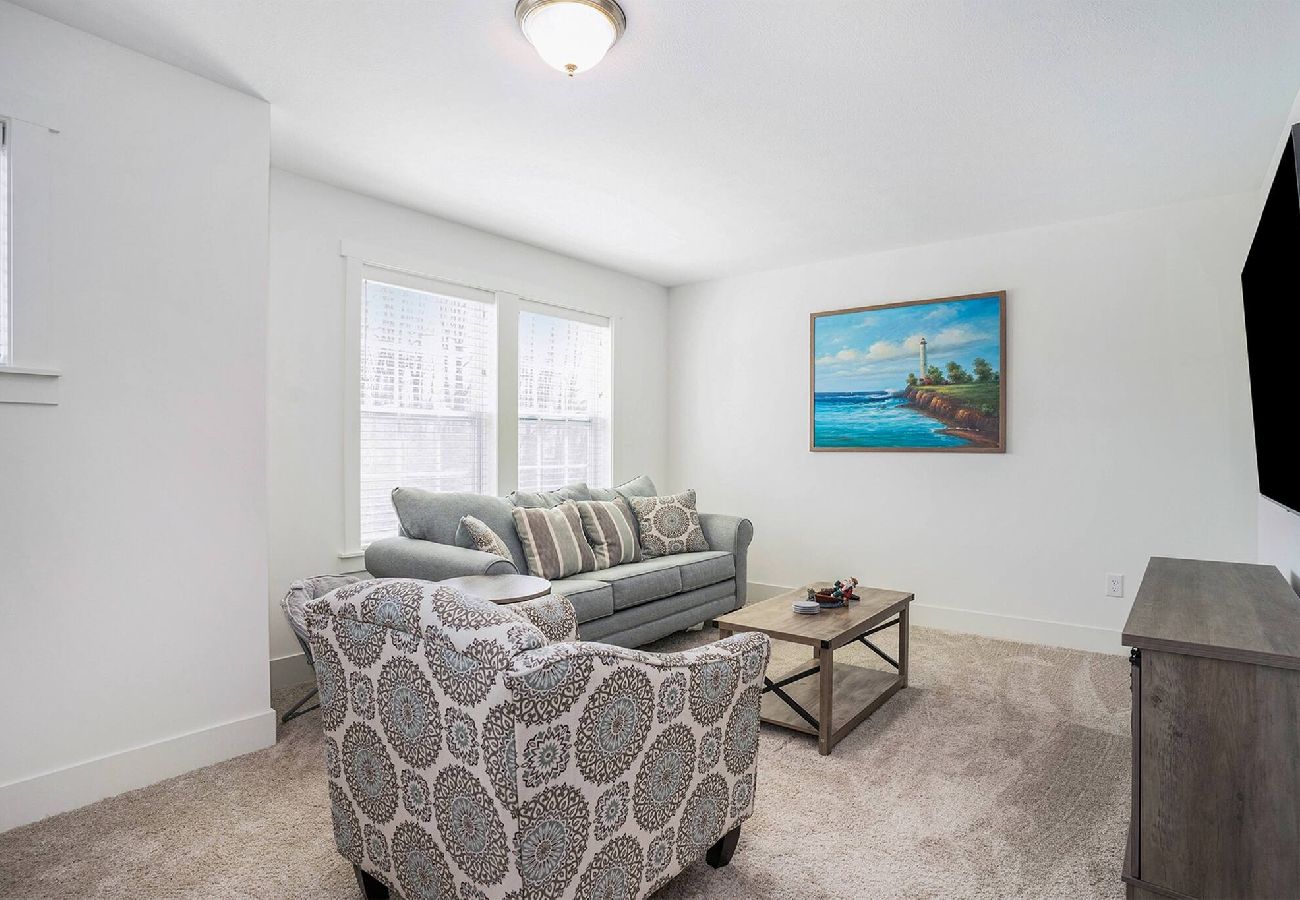 Second level sitting area with pull out couch and wall-mounted TV