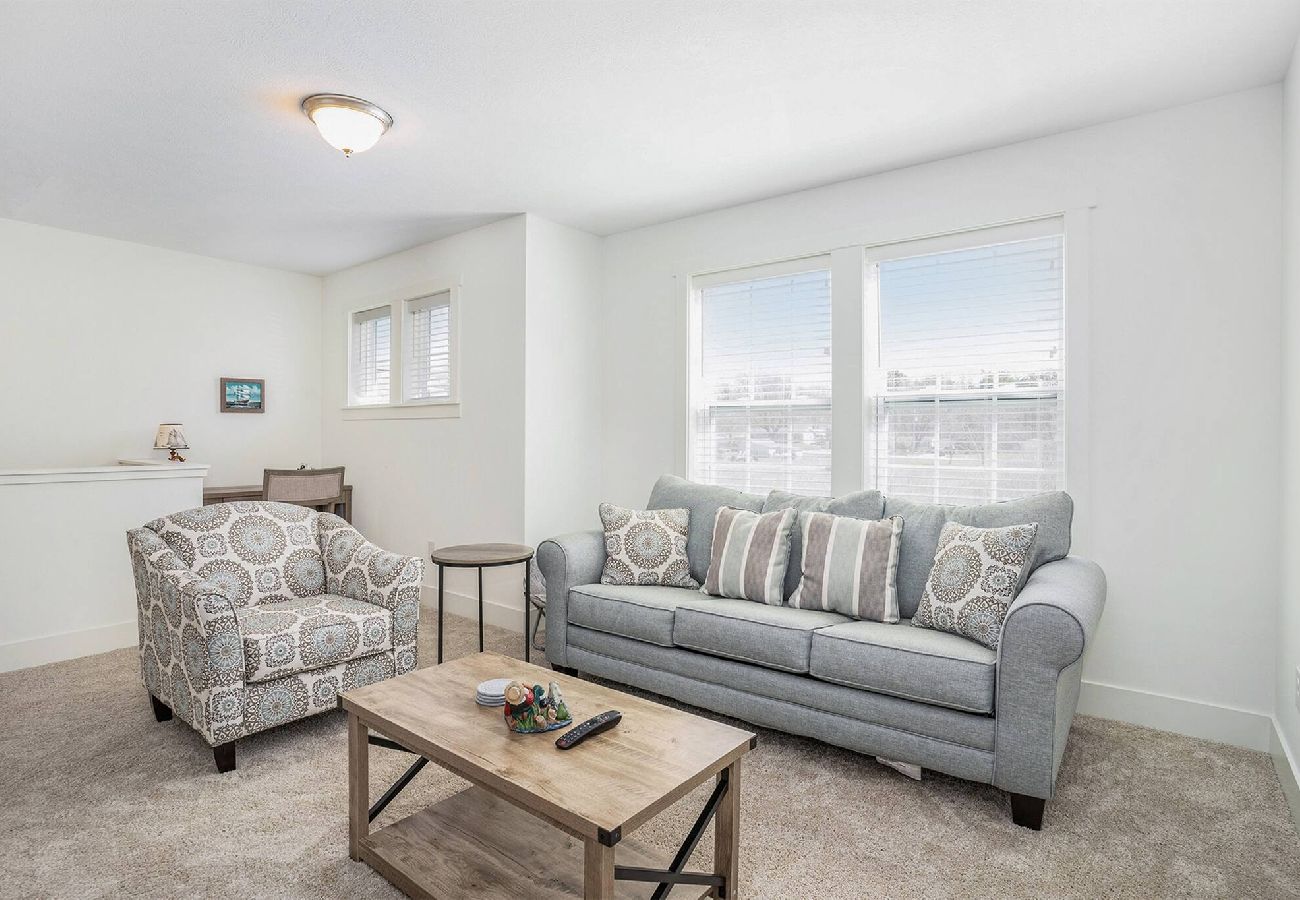 Upstairs living room with pull-out couch and armchair