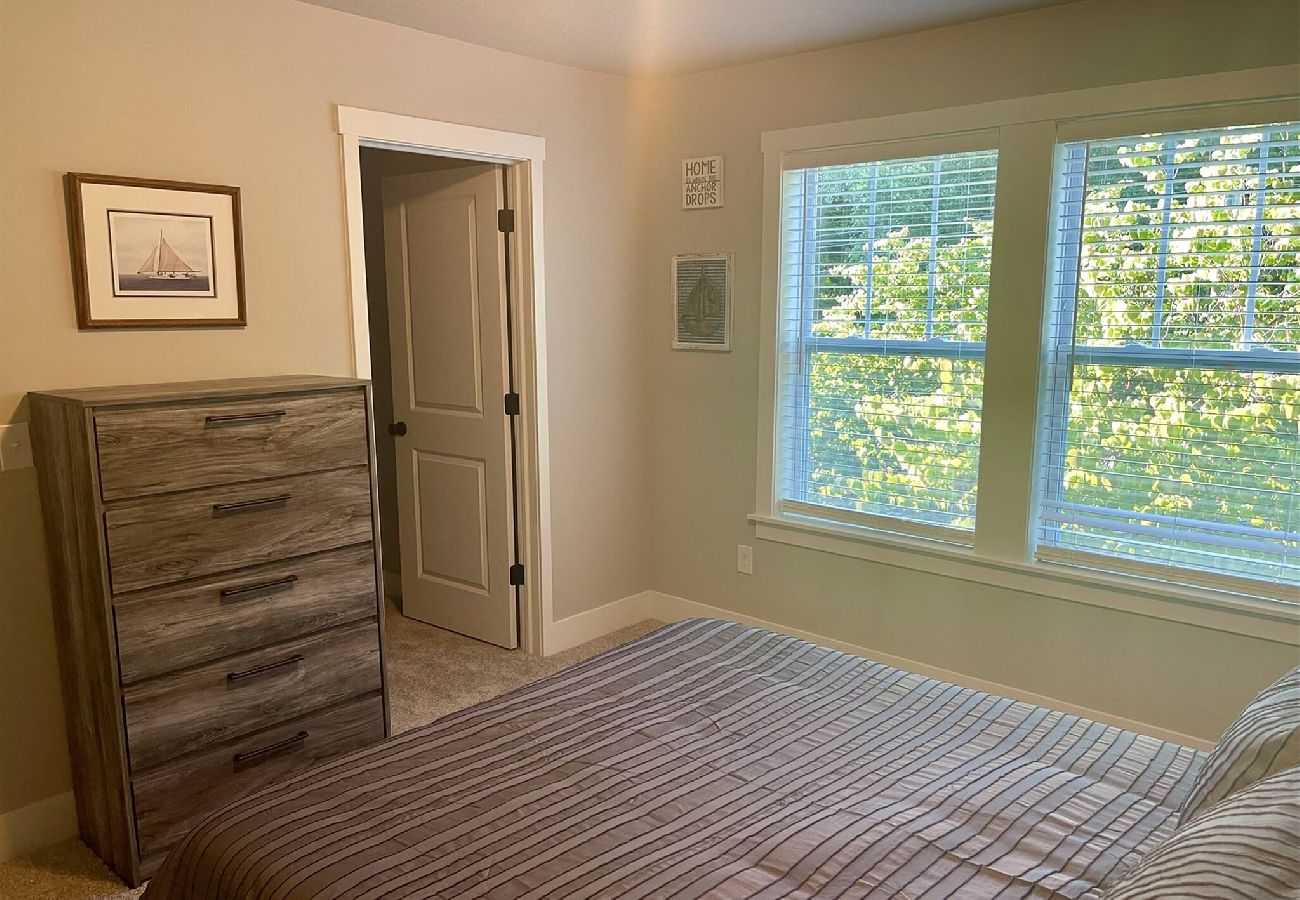 Bedroom with large windows over looking trees