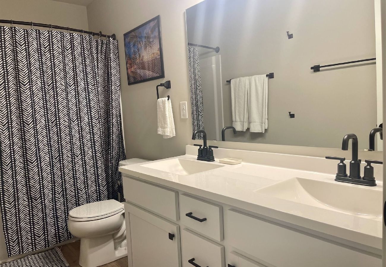 Bathroom with double sink vanity, and black fixtures