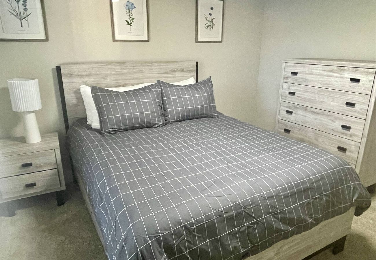 Queen bedroom, wooden bed frame, matching dresser and nightstand