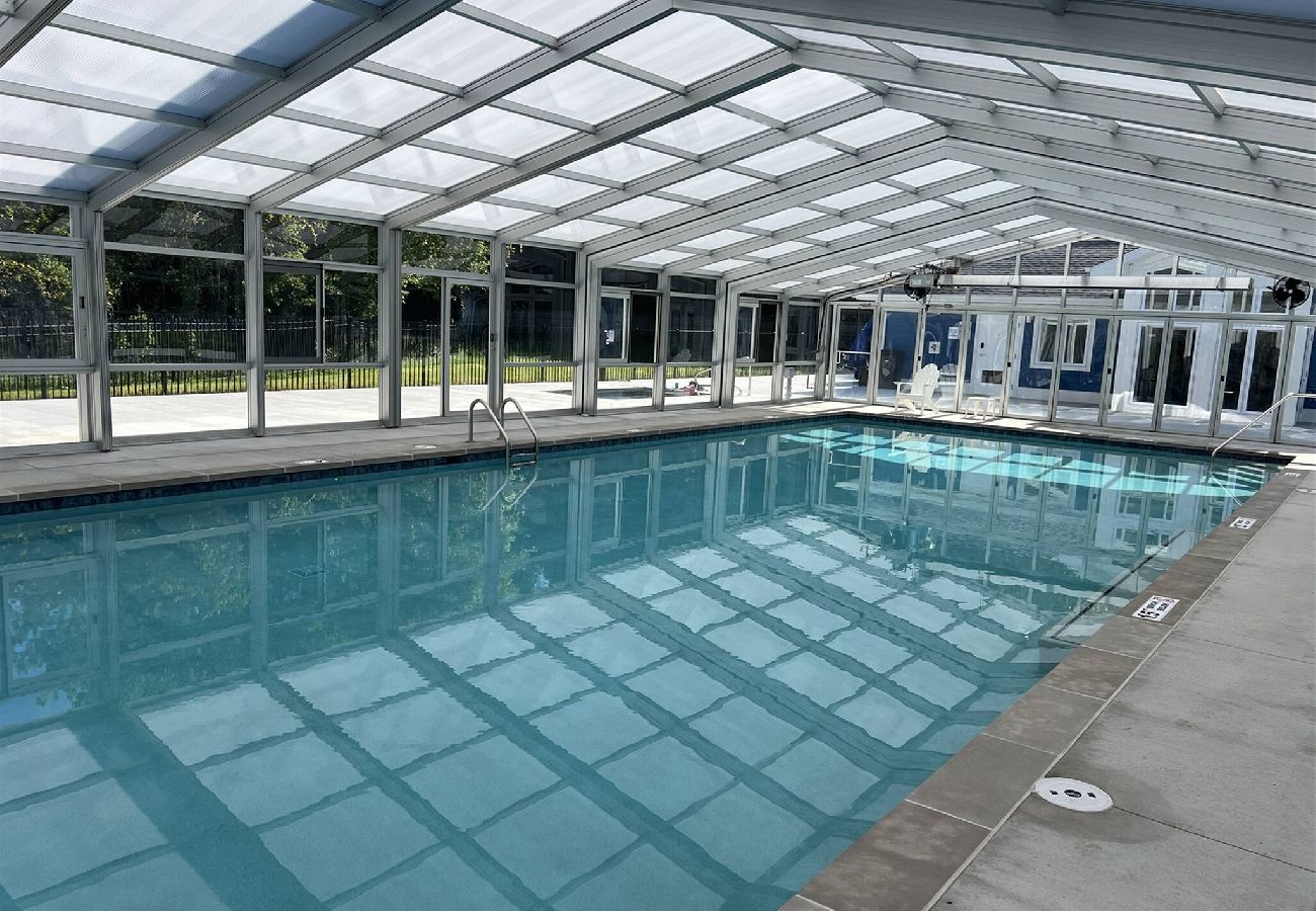 Indoor/outdoor heared pool with glass enclosure
