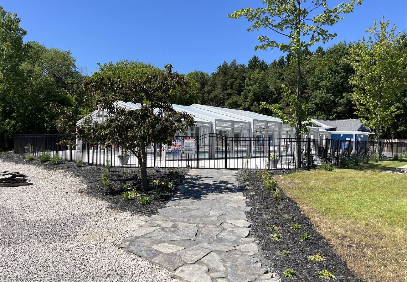 Stone walkway leading to gated indoor/outdoor pool