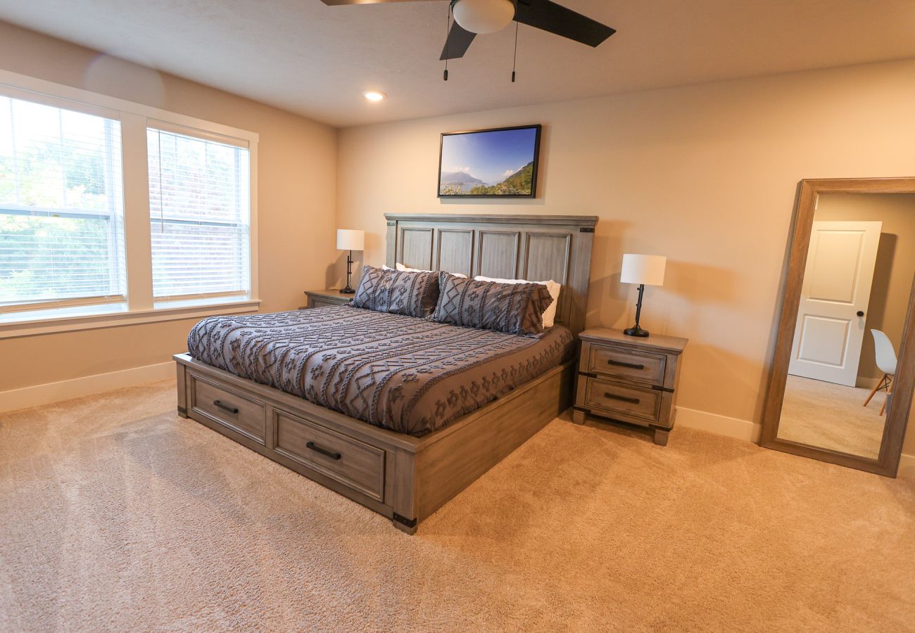   Bedroom with king-size bed,  bedside table, and floor length mirror