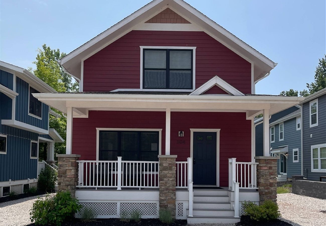 Two-story red cottage located in the Harbor Club community