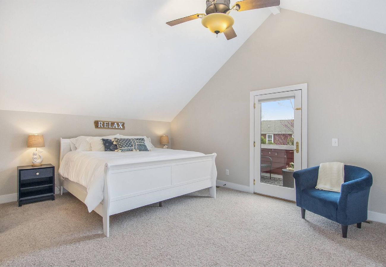 Primary bedroom with king bed, en-suite bathroom, and patio access in South Haven