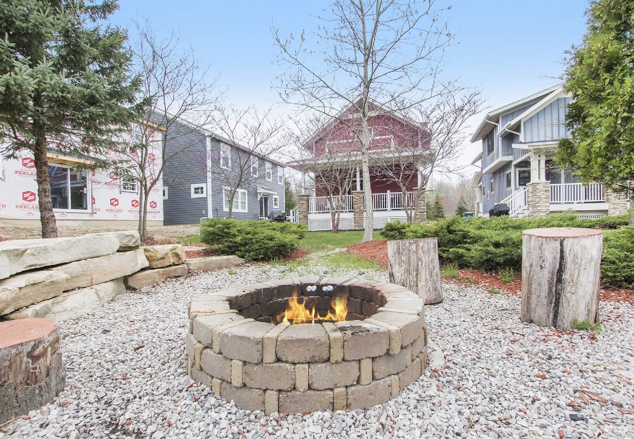Communal fire pit with log seating and brick fire ring.