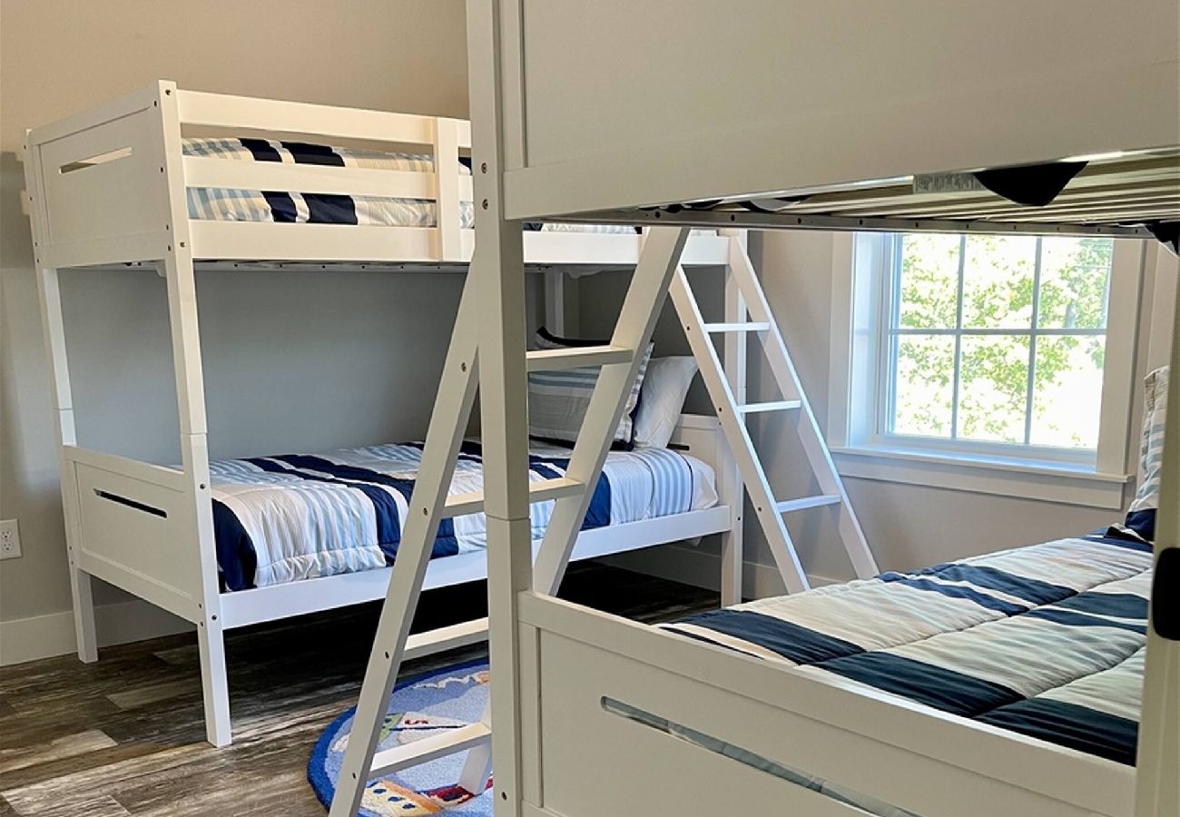 Bedroom with two white bunk beds