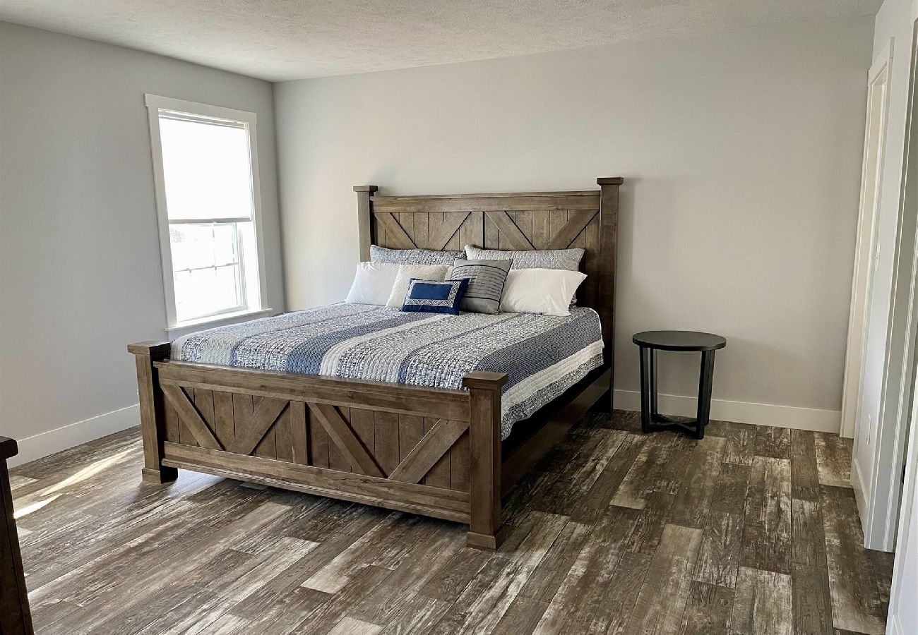Primary bedroom with large wooden bed