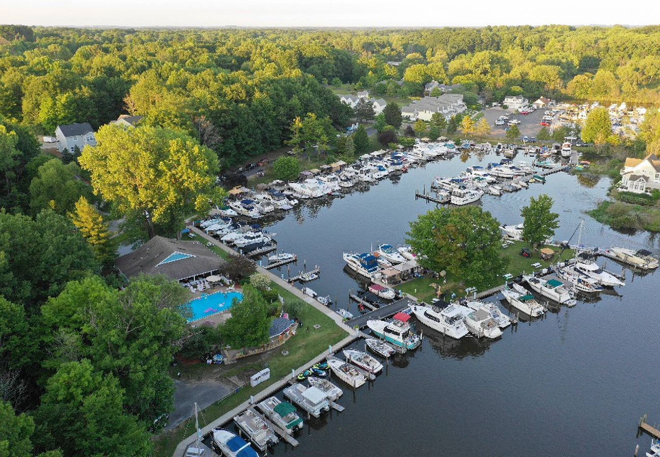 Aerial view of Woodland Harbor marina with boats docked along the waterfront, and home to Blue Water Boat Rentals