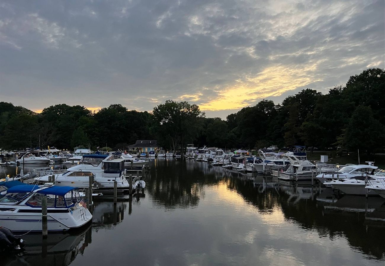 Sunset view of boats docked at a peaceful marina seen from the back patio at Shoreside Haven