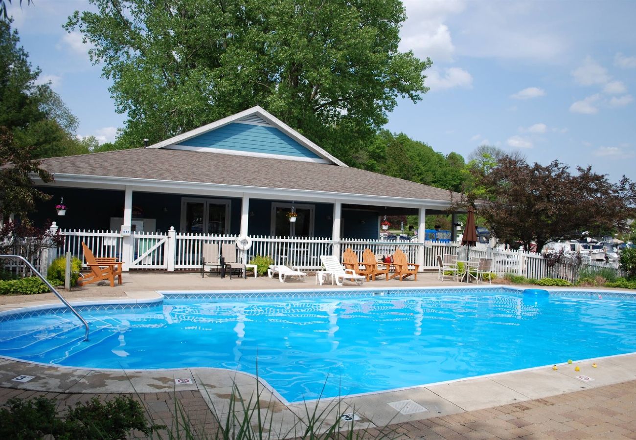 Outdoor pool and clubhouse at Woodland Harbor marina