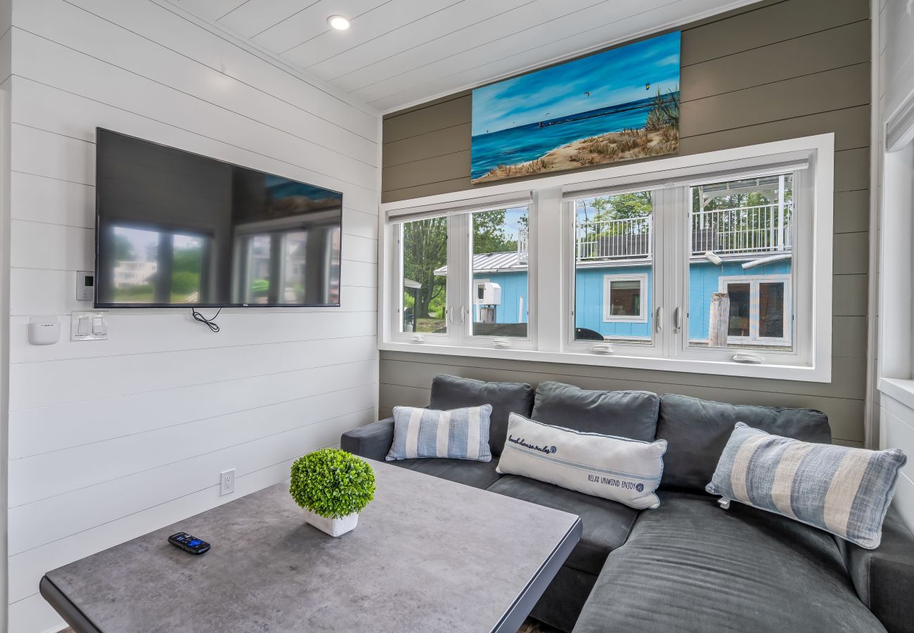 Living room with sectional pull-out couch and mounted TV 