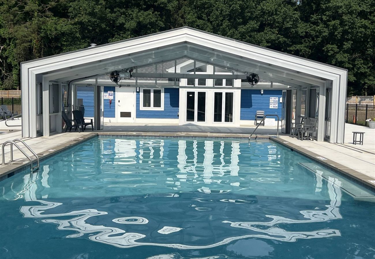 Indoor outdoor pool with clear retractable enclosure