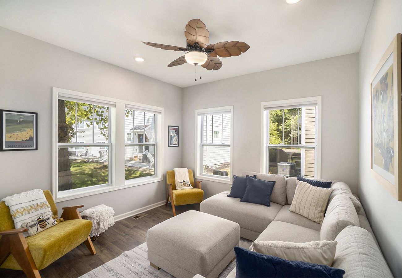 Bright sunroom lounge with large sectional and accent chairs