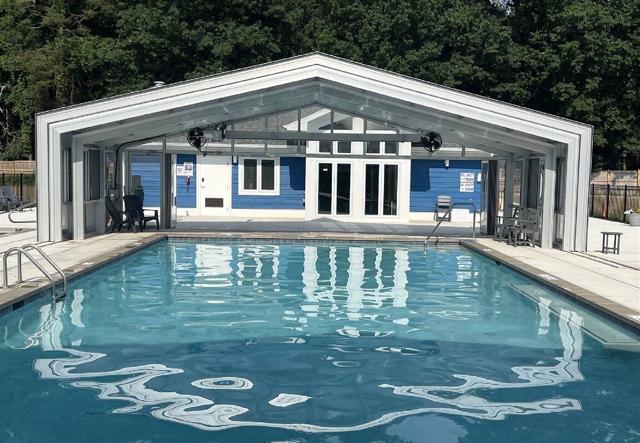 Indoor outdoor pool with retractable enclosure and pool house at Harbor Club in South Haven MI