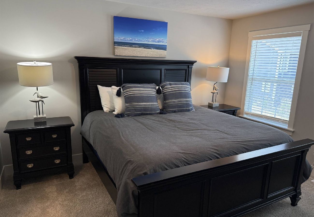 Primary bedroom with king bed, matching night stands in South Haven,MI