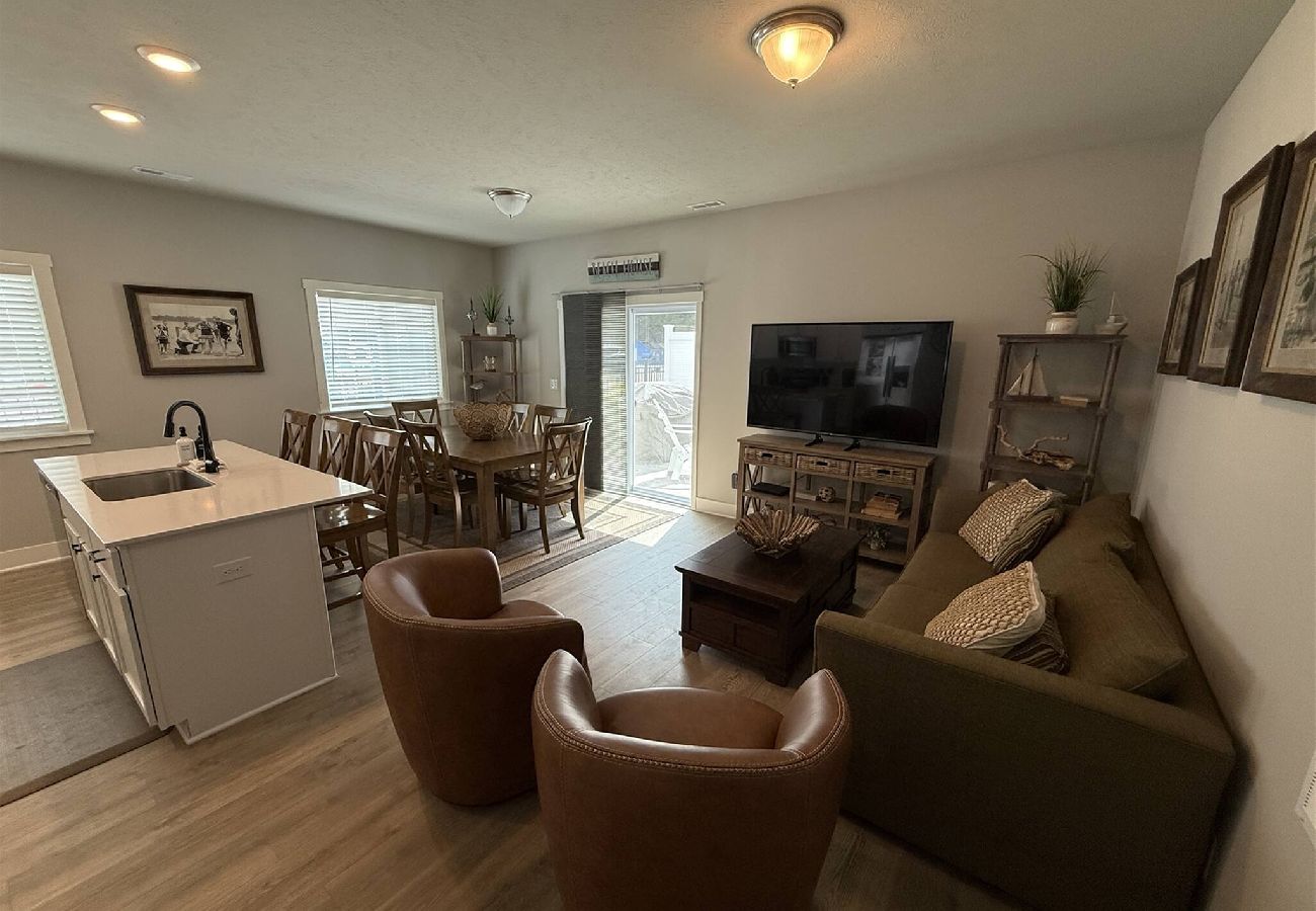 Open living space with kitchen island, dining table, sofa, and Tv in South Haven, MI